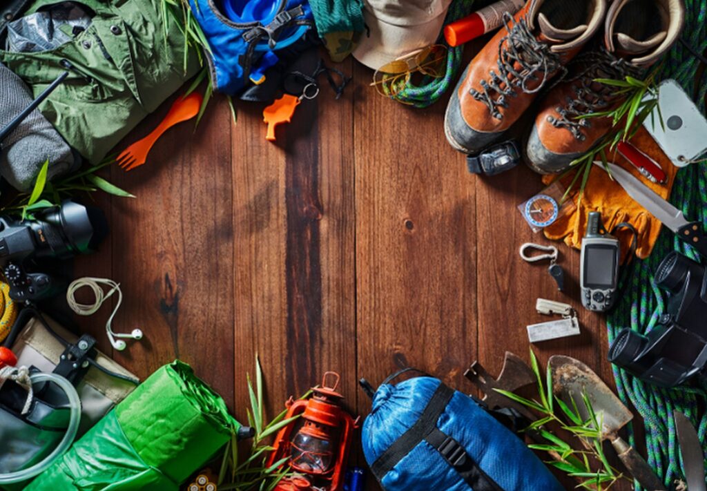 Das Ganze Equipment, das man zum Wandern braucht liegt gut sortiert auf dem Boden.